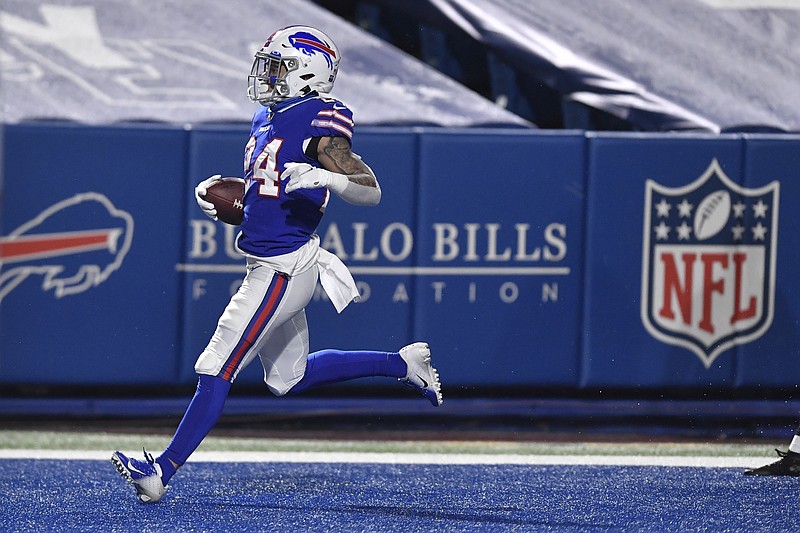 Buffalo Bills' Taron Johnson (24) returns an interception for a touchdown during the second half of an NFL divisional round football game against the Baltimore Ravens Saturday, Jan. 16, 2021, in Orchard Park, N.Y. (AP Photo/Adrian Kraus)