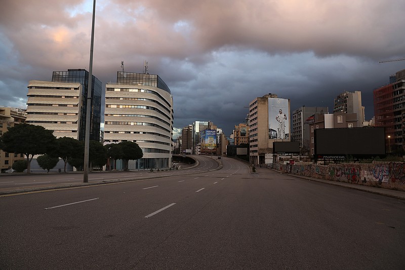 A street is empty of cars during a lockdown aimed at curbing the spread of the coronavirus, in Beirut, Lebanon, Friday, Jan. 15, 2021. Lebanon's parliament has approved a draft law to allow the importing of vaccines into the tiny country to fight the spread of coronavirus. (AP Photo/Bilal Hussein)