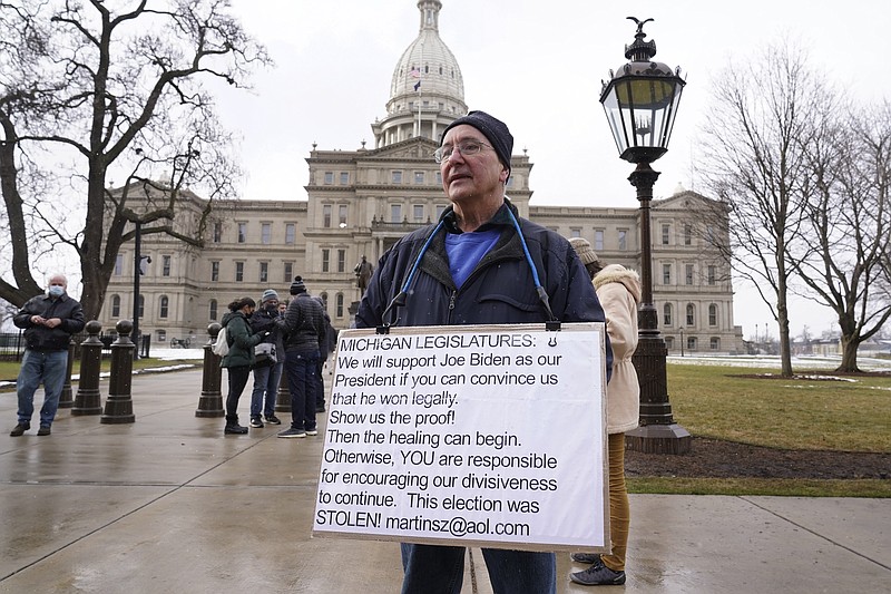 Martin Szelag stands outside the state capitol in Lansing, Mich., Sunday, Jan. 17, 2021. (AP Photo/Paul Sancya)