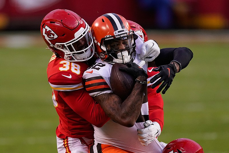 Cleveland Browns wide receiver Rashard Higgins is tackled by Kansas City Chiefs safety L'Jarius Sneed (38) after catching a pass during the second half of an NFL divisional round football game, Sunday, Jan. 17, 2021, in Kansas City. (AP Photo/Charlie Riedel)