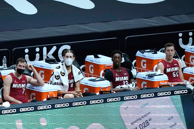 Miami Heat guard Goran Dragic (7), forward Kelly Olynyk, center Bam Adebayo (13) and guard Duncan Robinson (55) watch during the second half of an NBA basketball game against the Detroit Pistons, Saturday, Jan. 16, 2021, in Miami. (AP Photo/Lynne Sladky)