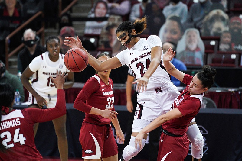 South Carolina guard LeLe Grissett (24) drives to the hoop against Arkansas guard Amber Ramirez, right, during the first half of an NCAA college basketball game Monday, Jan. 18, 2021, in Columbia, S.C. (AP Photo/Sean Rayford)