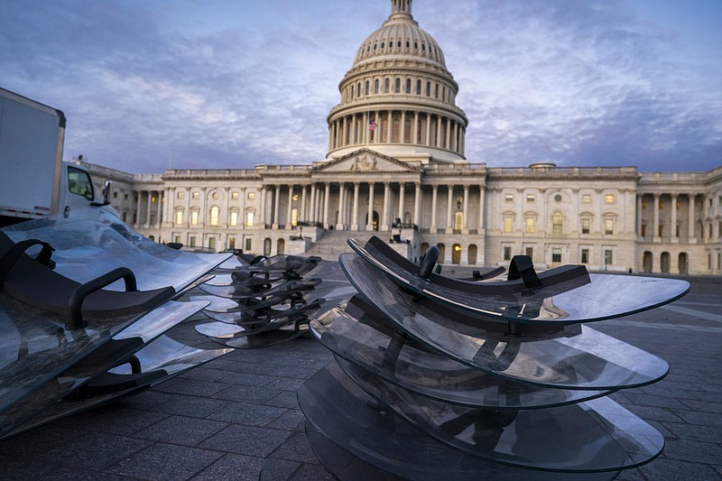 Riot shields are stacked at the ready as National Guard troops reinforce the security zone on Capitol Hill in Washington, Tuesday, Jan. 19, 2021, before President-elect Joe Biden is sworn in as the 46th president on Wednesday. (AP Photo/J. Scott Applewhite)