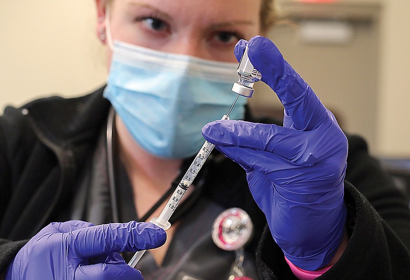 Paige Czeschin prepares individual doses of COVID-19 vaccines to administer to the public Tuesday, Jan. 19, 2021, at Capital Region Medical Center in Jefferson City.