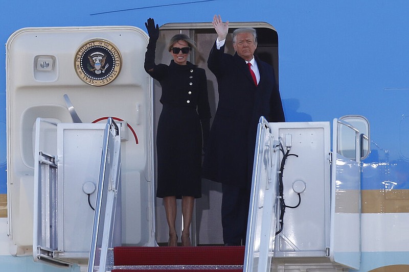 President Donald Trump and first lady Melania Trump wave to a crowd as they board Air Force One at Andrews Air Force Base, Md., Wednesday, Jan. 20, 2021. (AP Photo/Luis M. Alvarez)