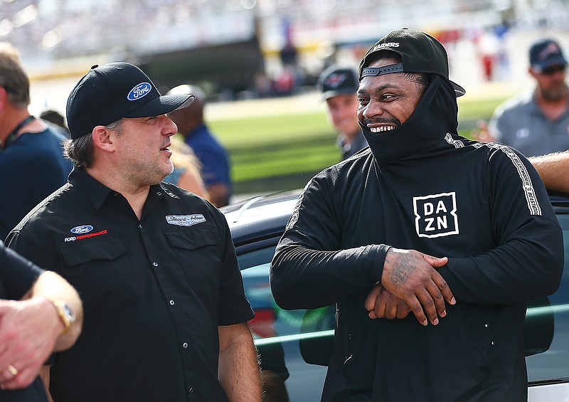 In this Sept. 15, 2019, file photo, Tony Stewart talks with former NFL player Marshawn Lynch before a NASCAR Cup Series race at Las Vegas Motor Speedway in Las Vegas.