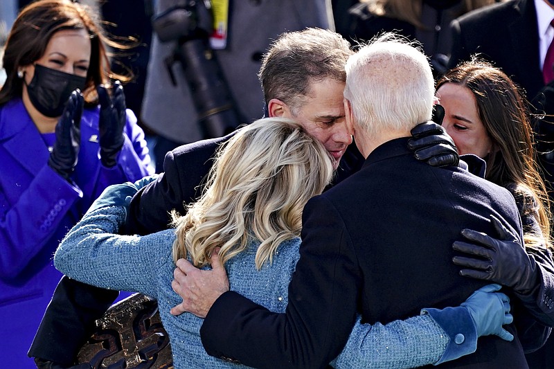 U.S. Vice President Kamala Harris applauds as President Joe Biden is embraced by his son Hunter,  first lady Jill Biden and daughter Ashley, during the 59th presidential inauguration in Washington, Wednesday, Jan. 20, 2021. (Kevin Dietsch/Pool Photo via AP)