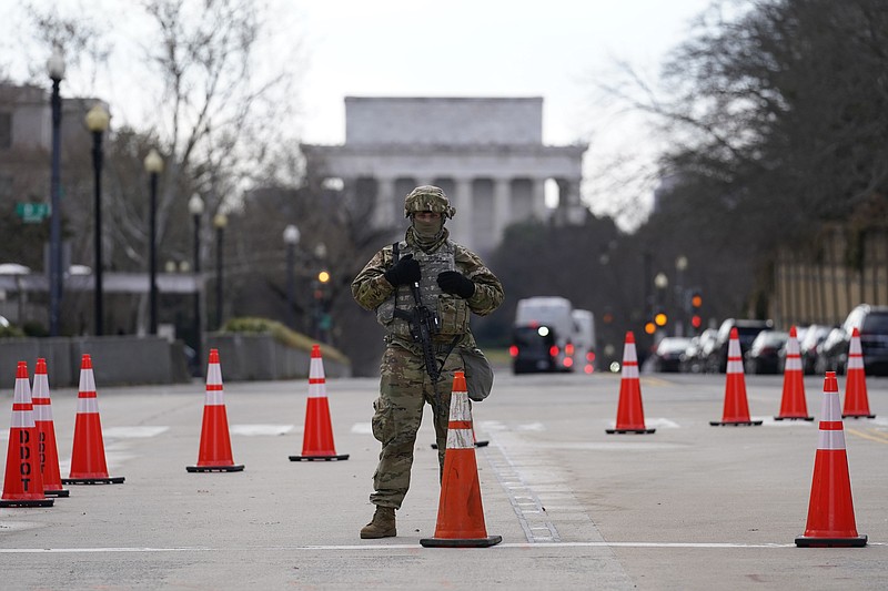 A National Guard stands at a road block near the Supreme Court ahead of President-elect Joe Biden's inauguration ceremony, Wednesday, Jan. 20, 2021, in Washington. (AP Photo/Gerald Herbert)