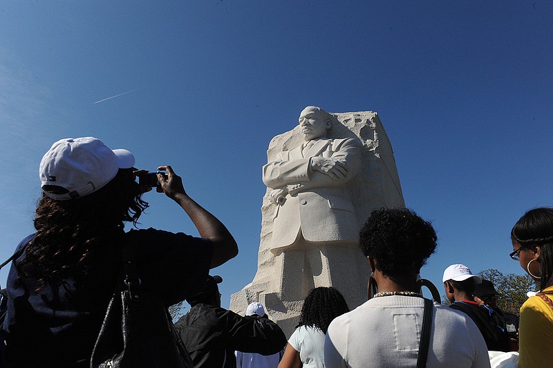 People take pictures during a dedication ceremony at the Martin Luther King Memorial on the National Mall, Sunday, October 16, 2011, in Washington, D.C. (Olivier Douliery/Abaca Press/TNS)