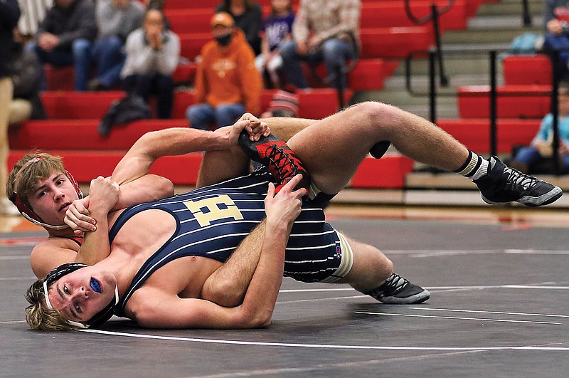 Blake Luebbering of Helias tries to shake off Michael Friederich of Jefferson City during a 182-pound match Wednesday night at Fleming Fieldhouse.