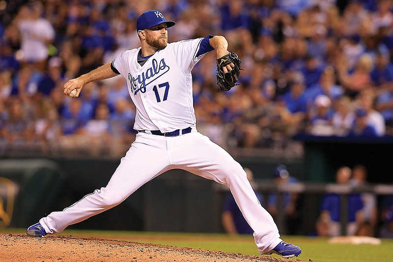 In this June 13, 2016, file photo, Royals relief pitcher Wade Davis throws during a game against the Indians at Kauffman Stadium in Kansas City. Davis is returning to the Royals, the team he helped pitch to the 2015 World Series title. 