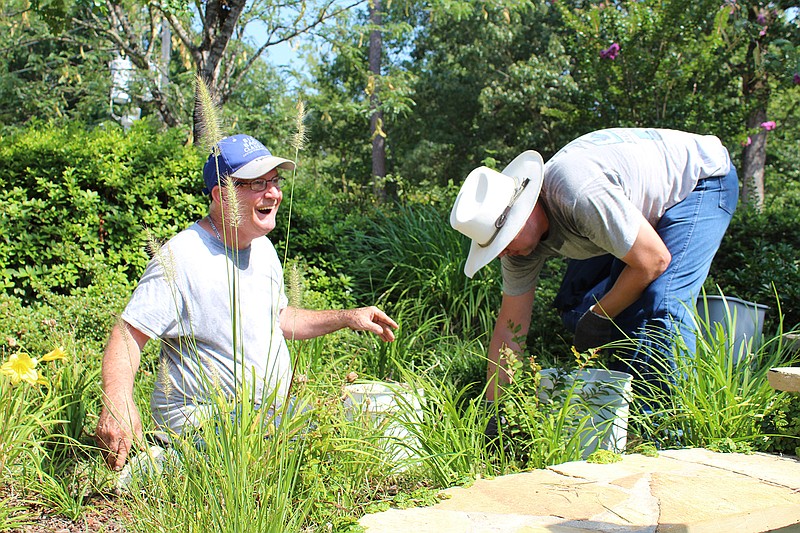 Two of Opportunities' adult clients work in one of the gardens on the wellness trail. (Photo courtesy of Rebekah Drennon)
