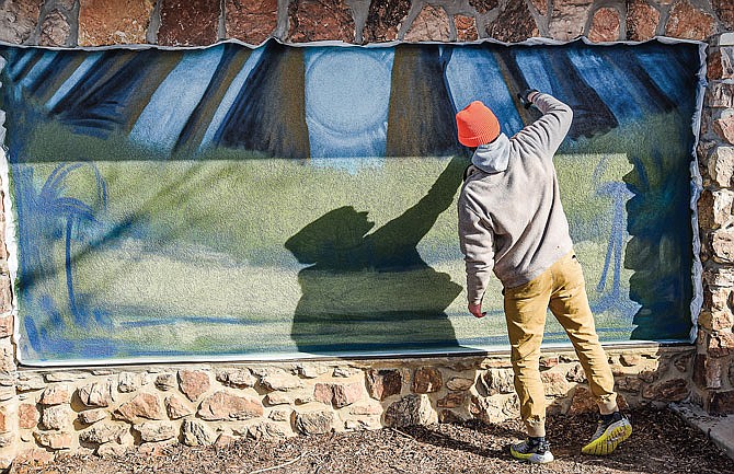 Alex Eickhoff uses spray paint to create a mural on the exterior wall of the newly remodeled McClung Park Pavilion. This particular mural was among multiple submissions from which the Jefferson City native's rendering was chosen.