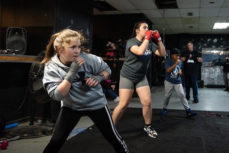 Boxing student Makenzie May, left, practices with her classmates during a session at Texarkana Boxing Academy on Tuesday. The class was led by coach Courtney Pitts.
