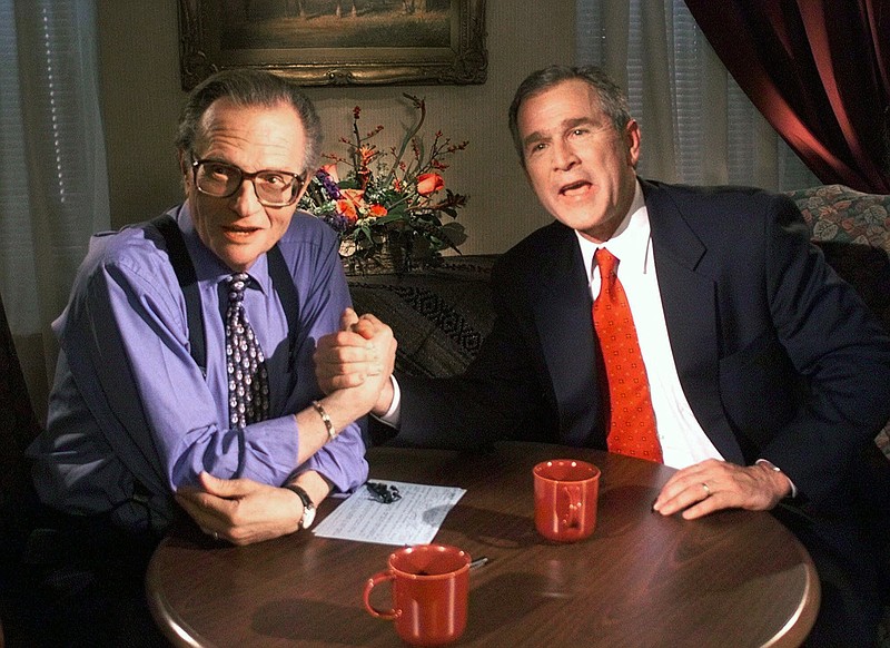 FILE - In this Dec. 16, 1999 file photo, Republican presidential candidate Texas Gov. George W. Bush jokes with CNN's Larry King after finishing the "Larry King Live" show from the Wildhorse Saloon in Nashville, Tenn.  King, who interviewed presidents, movie stars and ordinary Joes during a half-century in broadcasting, has died at age 87. Ora Media, the studio and network he co-founded, tweeted that King died Saturday, Jan. 23, 2021 morning at Cedars-Sinai Medical Center in Los Angeles.  (AP Photo/John Russell, file)