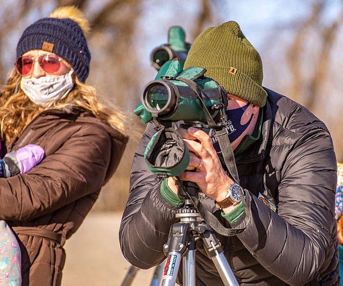 Missouri Department of Conservation naturalist Sam Stewart sets up a scope for eagle viewing Saturday at the Marion Access on Missouri 179.