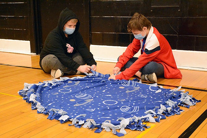 Fulton Middle School students in the Jobs for America's Graduates program tied blankets for children in foster care.