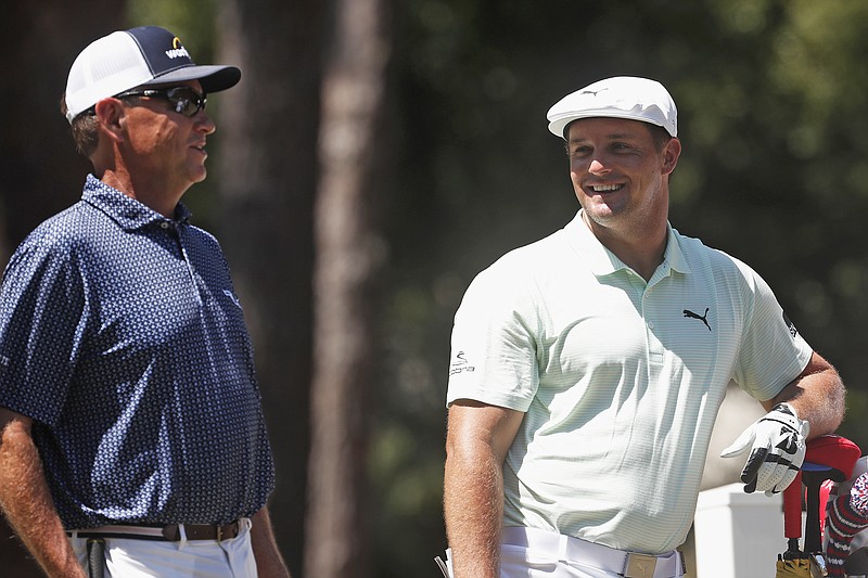 In this June 18. 2020, file photo, Davis Love III (left) and Bryson DeChambeau talk on the 11th tee during the first round of the RBC Heritage in Hilton Head Island, S.C.