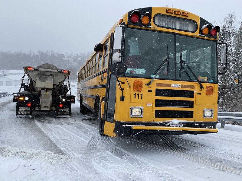 A school bus is stuck Wednesday, Jan. 27, 2021, as it tries to ascend a snow-covered hill on Renns Lake Road in Cole County.