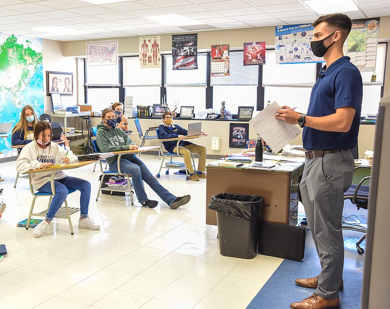 Clinton Campbell is substitute teaching in his dad, Dan Campbell's geography class this week at Helias Catholic High School. Campbell graduated from HHS in 2016 and is helping to fill a need at his alma mater. The COVID-19 pandemic has exacerbated the nationwide substitute teacher shortage — but while many Cole County schools don't have as many substitute teachers available as they would like, substitute teacher coverage has either improved or stayed the same throughout the school year.