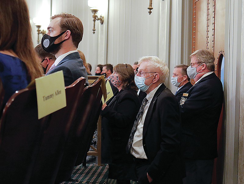 Liv Paggiarino/News TribuneRep. Rudy Veit, R-Wardsville, stands in the back of the gallery looking out onto the Senate floor Wednesday as he listens to Gov. Mike Parson's State of the State Address at the Missouri state Capitol. A crowd that included Parson's cabinet, state representatives, special guests and media was gathered in the senate gallery to watch the speech. The speech was livestreamed and also projected on a screen in the Capitol Rotunda, which had been turned into an "overflow" area to promote social distancing. 