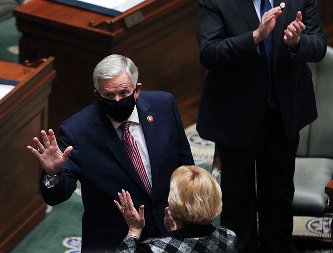 Gov. Mike Parson waves to senators Wednesday as he enters the Senate Chambers to give his State of the State Address. Parson announced the new Office of Childhood during his 2021 address.