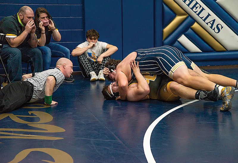 Michael Sanner of Helias works for the pin against Tyler Soendker of Sedalia Smith-Cotton during their 285-pound match Saturday in the CMAC Tournament at Rackers Fieldhouse.