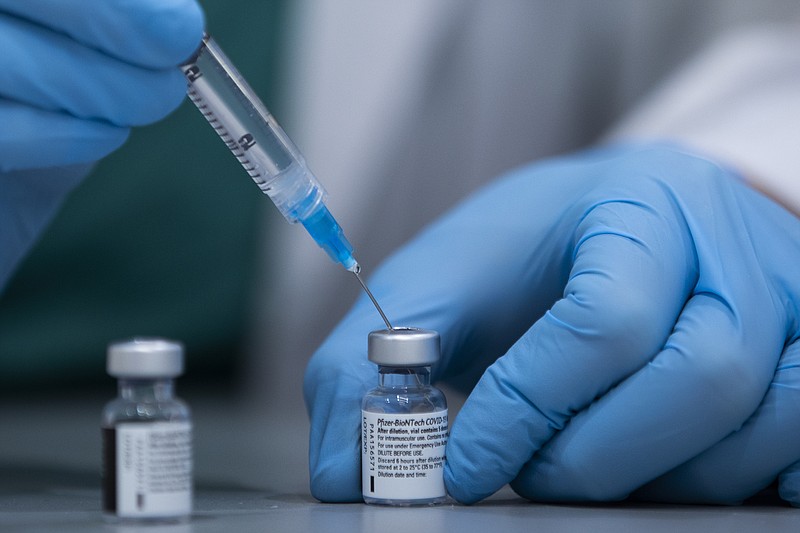 FILE - In this Jan. 12, 2021 file photo, a health care professional prepares a Pfizer-BioNTech COVID-19 vaccine at Sheba Tel Hashomer Hospital in Ramat Gan, Israel. Israel Defense Minister Benny Gantz’s office said Sundya, Jan. 31, 2021, that Israel has agreed to transfer 5,000 doses of the coronavirus vaccine to the Palestinians to immunize front-line medical workers. It is the first time that Israel has confirmed the transfer of vaccines to the Palestinians. (AP Photo/Oded Balilty, File)