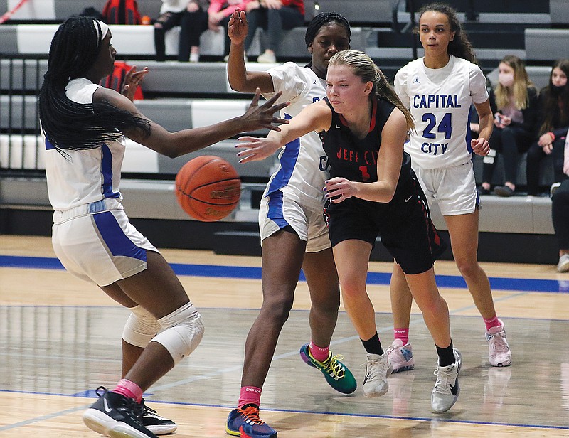 Hannah Nilges of Jefferson City makes a pass among Capital City defenders during Tuesday night's game at Capital City High School.