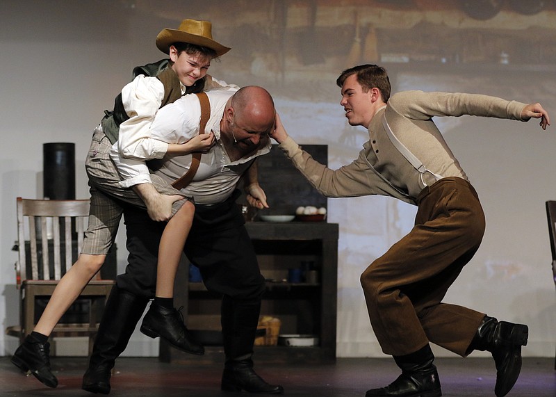 Liv Paggiarino/News Tribune

Cole Riney, Ben Miller and Wyatt Logan, playing Jody Baxter, Lem and Oliver Hutt, respectively, perform a fight scene during Wednesday’s rehearsal for “The Yearling” at Capital City Productions. The play follows the coming of age of a boy in the Florida scrub after the Civil War. CCP’s rendition of “The Yearling” will debut on February 11, and the show will subsequently run on Feb. 13, 18, 19 and 20. 