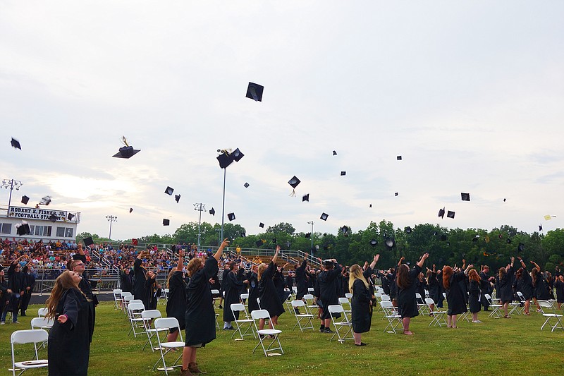 <p>Helen Wilbers/FULTON SUN Backed by the setting sun, graduates in Fulton High School’s Class of 2020 toss their caps into the air. The Fulton Board of Education is discussing to handle the 2021 graduation ceremony.</p>