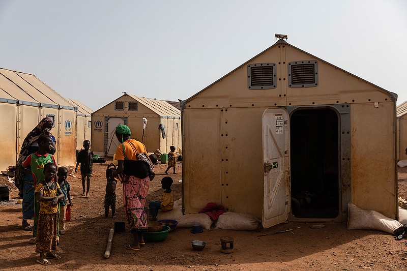 Women and children stand in the Kaya camp, 100 kms North of Ouagadougou, Burkina Faso, Monday Feb. 8, 2021. A senior United Nations official says Burkina Faso is on the brink of becoming a protracted crisis after extremist violence displaced over 1 million people. Ramesh Rajasingham spoke to The Associated Press Friday, Feb. 12 after visiting the hard-hit Center North and Sahel regions in the country that has been engulfed in extremist violence for more than five years. (AP Photo/Sophie Garcia)