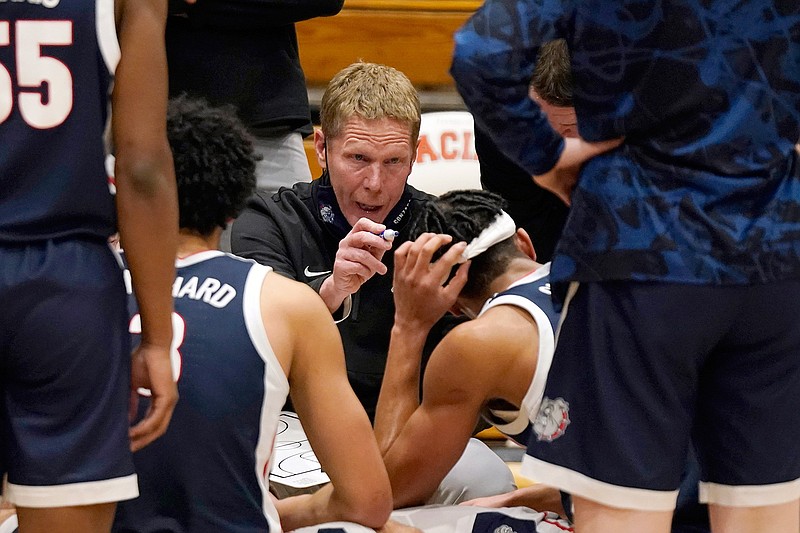 In this Feb. 4, 2021, file photo, Gonzaga coach Mark Few huddles with his team during a timeout in the second half of an NCAA college basketball game against Pacific in Stockton, Calif. Few isn't being asked questions about where his team should be seeded for next month's NCAA Men's Basketball Tournament. Instead, the longtime coach is getting a different question with a little more than a month until Selection Sunday — does it make any sense for Gonzaga to compete in its conference tournament? (AP Photo/Rich Pedroncelli, File)