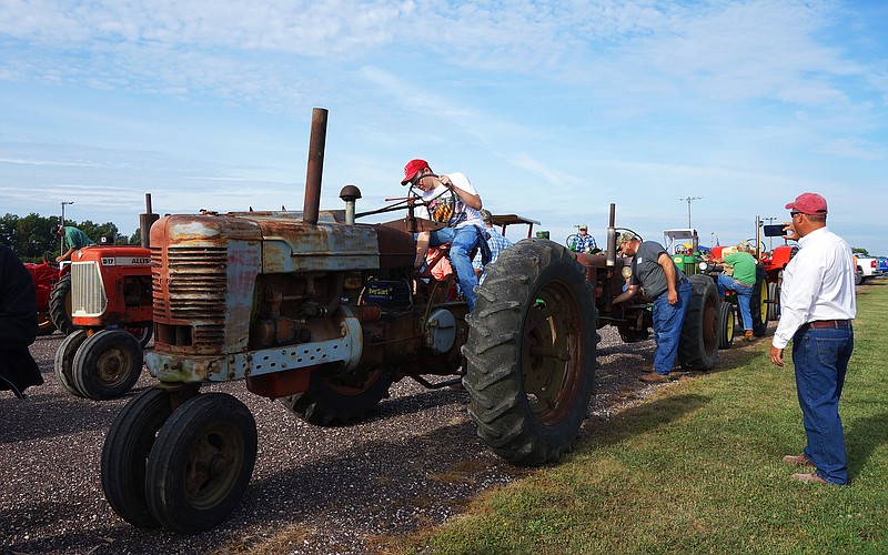 Seth Elley starts up one of his father's tractors during the Kingdom of Callaway Historical Society's 2019 annual Tractor Drive. This year, the historical society hopes to gather 200 vintage tractors at the Aug. 28 event.