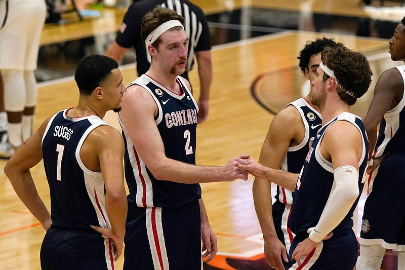 FILE - In this Feb. 4, 2021, file photo, Gonzaga's Drew Timme, second from left, and Corey Kispert shake hands in the closing moments of Gonzaga's 76-58 win over Pacific in an NCAA college basketball game in Stockton, Calif. Gonzaga coach Mark Few isn't being asked questions about where his team should be seeded for next month's NCAA Men's Basketball Tournament. Instead, the longtime coach is getting a different question with a little more than a month until Selection Sunday — does it make any sense for Gonzaga to compete in its conference tournament? (AP Photo/Rich Pedroncelli, File)