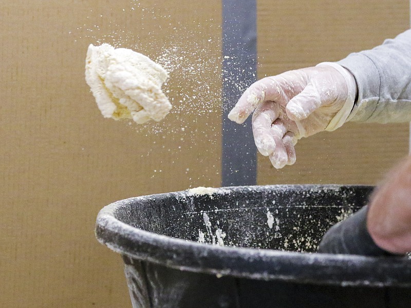 In this News Tribune file photo, Mike Dolson tosses freshly breaded catfish into a tray to be taken out to the friers during the 2020 Knights of Columbus fish fry at St. Andrew Catholic Church in Holts Summit.