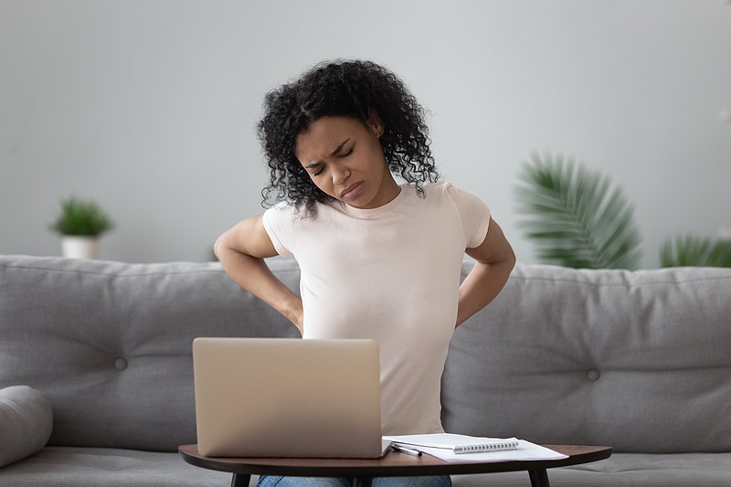 As the one-year mark to the pandemic approaches, chiropractors and orthopedic surgeons say working from home has meant more pain for many. (Dreamstime/TNS)