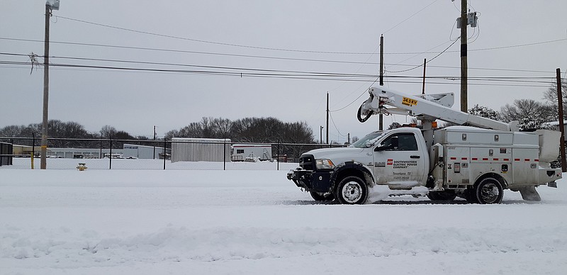 SWEPCO was out and about Thursday morning in Texarkana, one of the few things moving early. Wednesday night brought deeper snow covering a sheet of ice, making travel precarious. Trucking companies, among others, had grounded to a halt.
