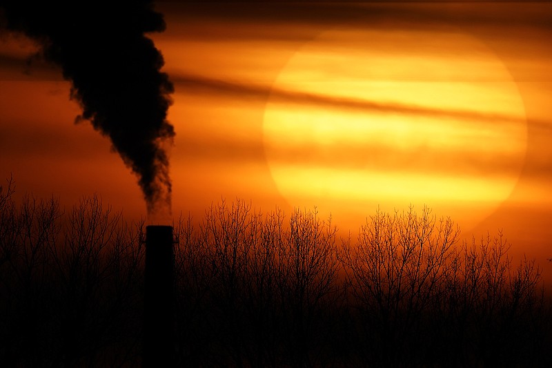 FILE - In this Monday, Feb. 1, 2021 file photo, emissions from a coal-fired power plant are silhouetted against the setting sun in Independence, Mo. A United Nations report released on Thursday, Feb. 18, 2021 says humans are making Earth a broken and increasingly unlivable planet through climate change, biodiversity loss and pollution. So the world must make dramatic changes to society, economics and daily life. (AP Photo/Charlie Riedel)