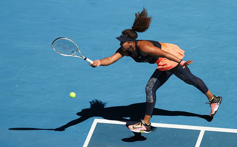 Japan's Naomi Osaka hits a forehand return to United States' Serena Williams during their semifinal match at the Australian Open tennis championship in Melbourne, Australia, Thursday, Feb. 18, 2021.(AP Photo/Hamish Blair)