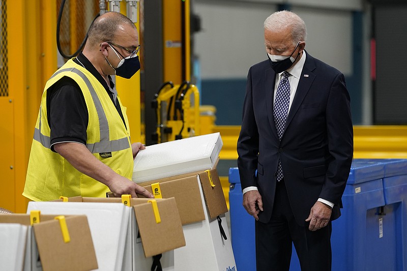 President Joe Biden tours a Pfizer manufacturing site, Friday, Feb. 19, 2021, in Portage, Mich. (AP Photo/Evan Vucci)
