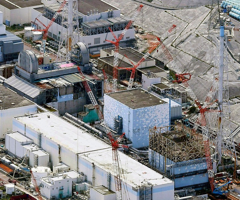 This Sept. 4, 2017, aerial file photo shows Fukushima Dai-ichi nuclear power plant's reactors, from bottom at right, Unit 1, Unit 2 and Unit 3, in Okuma, Fukushima prefecture, northeastern Japan. The utility operating a wrecked Fukushima nuclear plant said Friday, Feb. 19, 2021, it has detected cooling water levels at two of its three melted reactors have fallen over the past few days apparently due to additional damage done to its reactors from a powerful earthquake that shook the area last weekend.(Daisuke Suzuki/Kyodo News via AP, File)