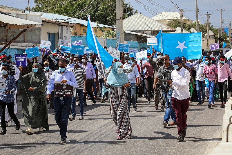 Somalis march and protest against the government and the delay of the country's election in the capital Mogadishu, Somalia Friday, Feb. 19, 2021. Security forces in Somalia's capital fired on hundreds of people protesting the delay of the country's election on Friday as at least one explosion was reported at the international airport and armored personnel carriers blocked major streets. (AP Photo)