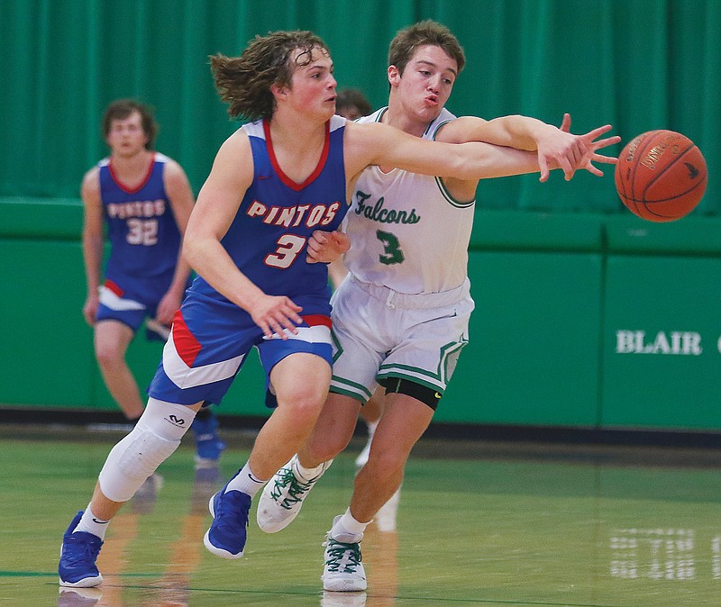 Jake Closser of Blair Oaks and Calen Kruger of California reach for a loose ball during Saturday's game at Blair Oaks High School.