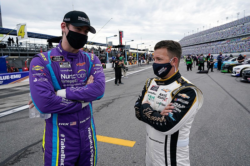 Cody Ware, left, and A J Allmendinger talk on pit road before the NASCAR Xfinity Series auto race at Daytona International Speedway, Saturday, Feb. 13, 2021, in Daytona Beach, Fla. (AP Photo/John Raoux)