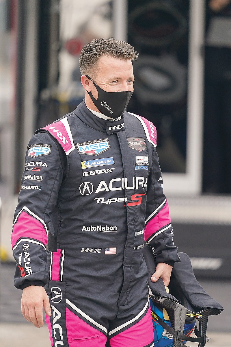 In this Jan. 23 file photo, AJ Allmendinger walks back to his garage after a practice session for the Rolex 24 at Daytona International Speedway in Daytona Beach, Fla.