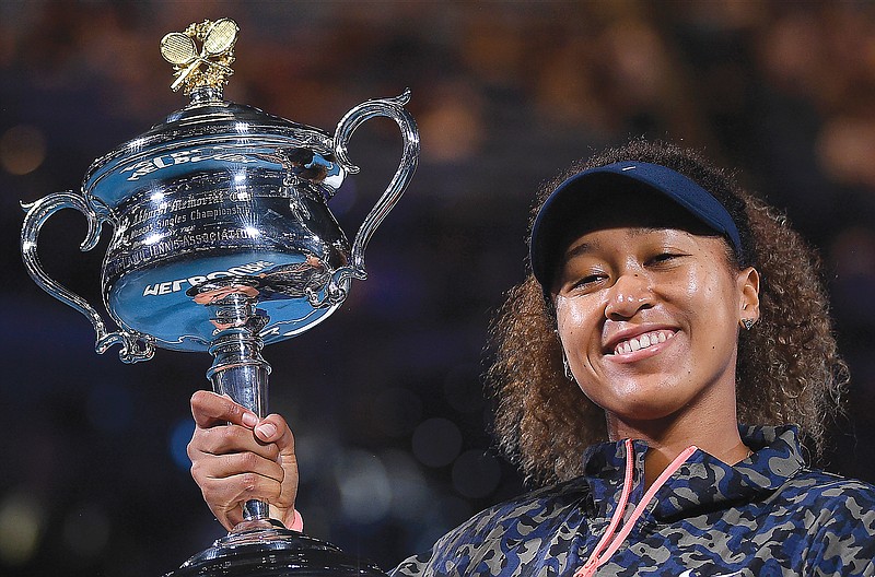 Naomi Osaka holds the trophy Saturday after defeating Jennifer Brady in the women's singles final at the Australian Open in Melbourne, Australia.