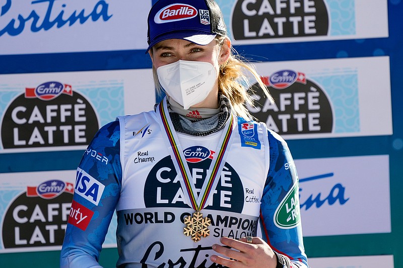 United States' Mikaela Shiffrin shows her bronze medal on the podium of the women's slalom, at the alpine ski World Championships in Cortina d'Ampezzo, Italy, Saturday, Feb. 20, 2021. (AP Photo/Giovanni Auletta)