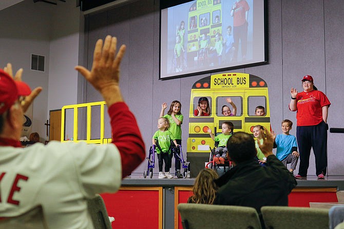 Children wave goodbye Saturday to the audience at the end of this year's Moments of Magic show at Calvary Lutheran High School. The children and their families attended and put on a show that was livestreamed to benefit the Special Learning Center and recognize all the work the center does to help children of different abilities.