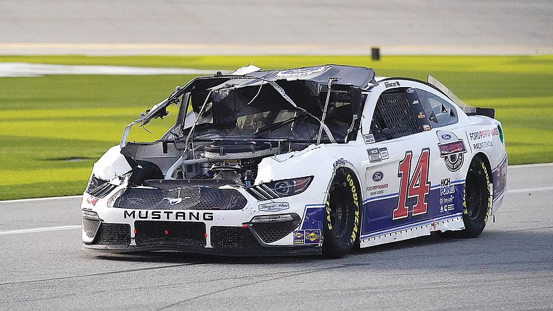 Chase Briscoe drives down pit road to repair damage to his car after he was in a crash Sunday during the NASCAR Cup Series road course race at Daytona International Speedway in Daytona Beach, Fla.
